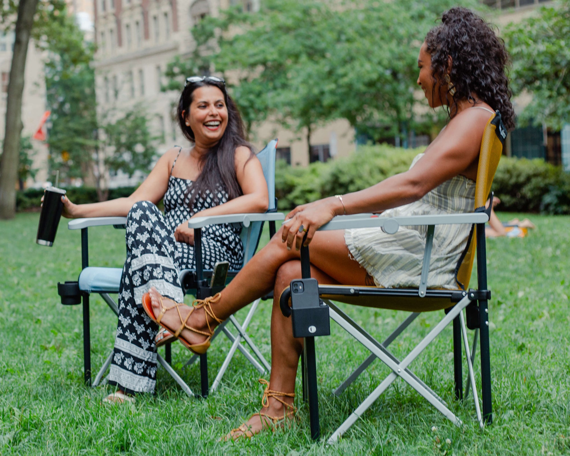 Enjoying time with friends in the park sitting in True Places Emmett folding chairs. Remarkable comfort in the modern outdoors, that also supports community non-profits providing access to public spaces and recreation.