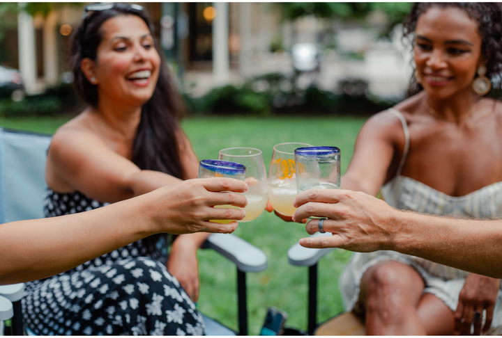 Toasting friends and enjoying the modern outdoors in True Places Emmett folding chairs. Our referral program makes it easy to help spread the word through the QR code on the back of each chair.